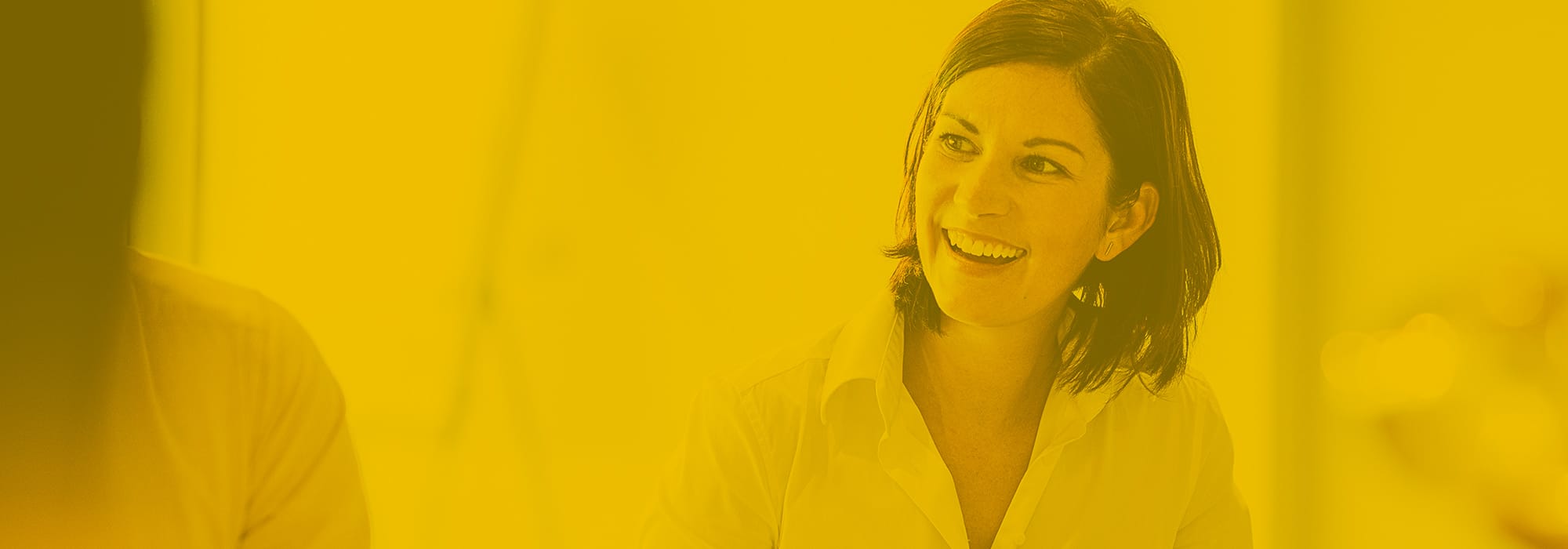 Cheerful mid adult woman smiling at business meeting