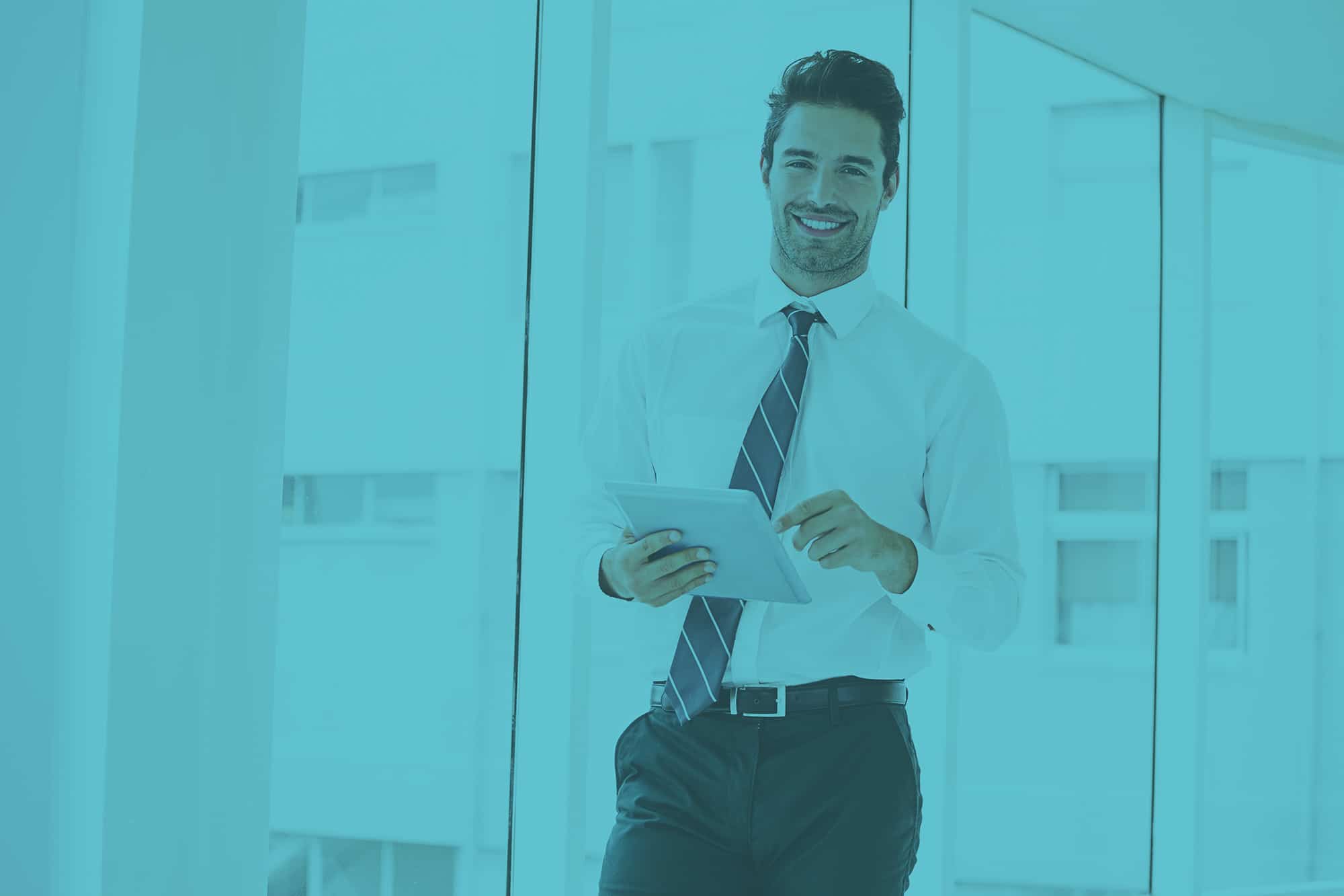 A,Man,Is,Holding,A,Notebook,And,Smiling,At,Office
