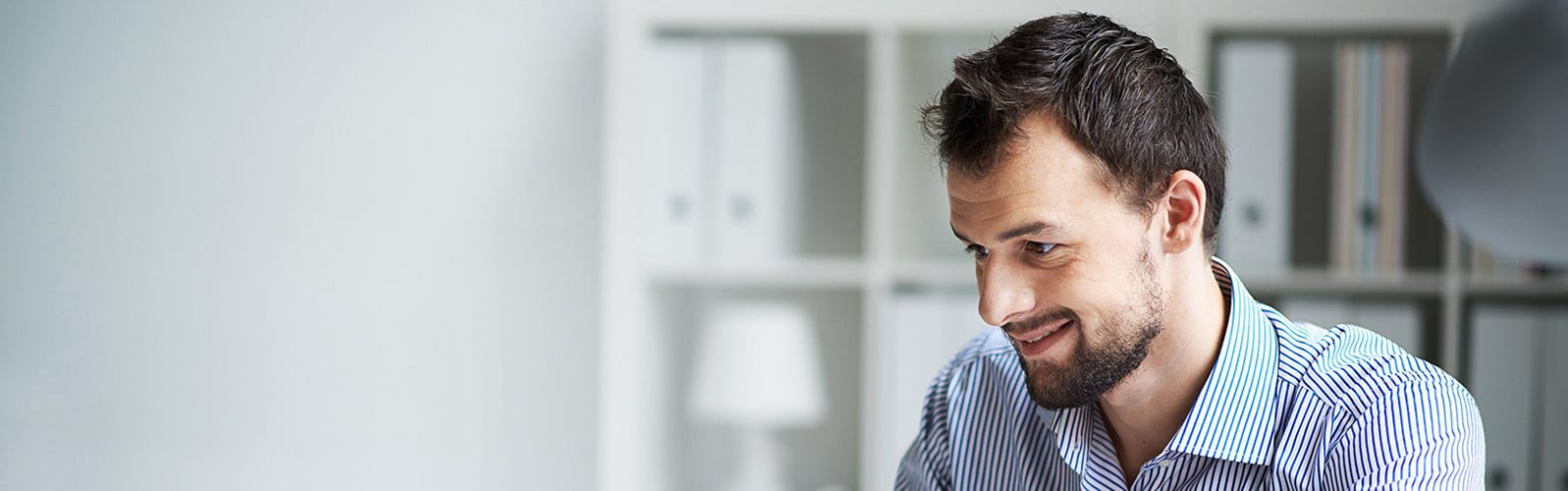 Handsome,Businessman,Working,With,Laptop,In,Office