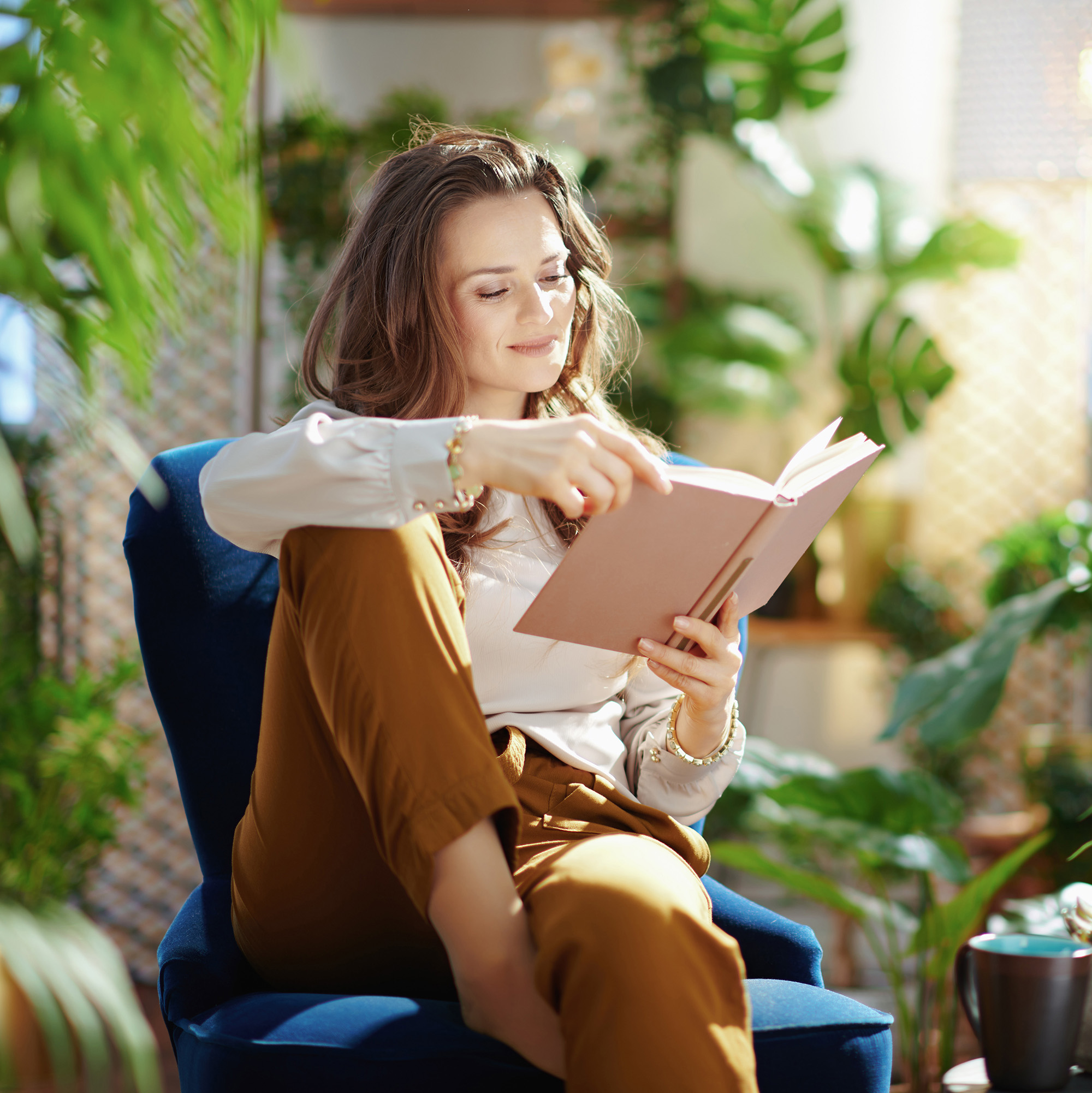 Woman with green plants around